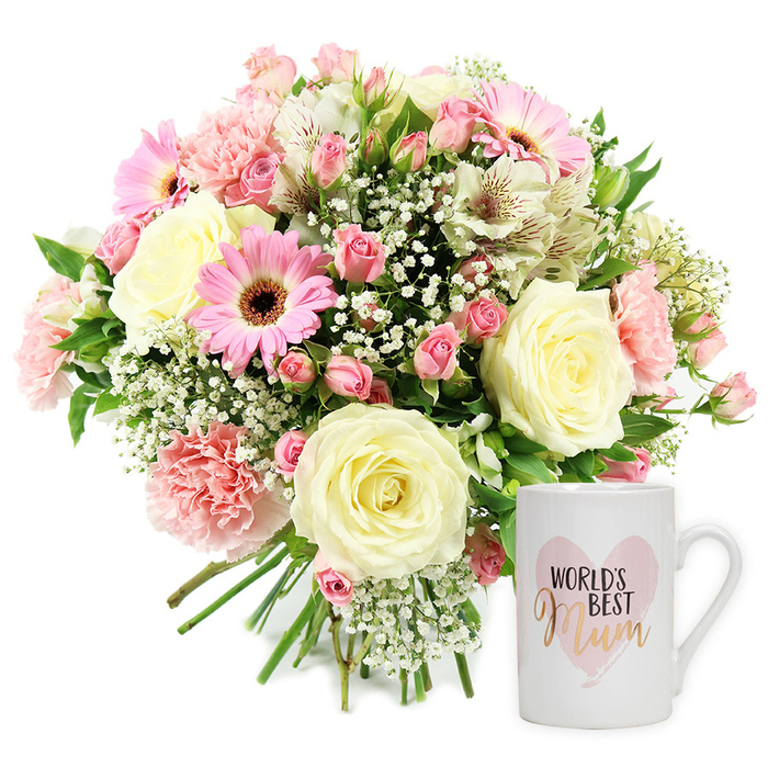 High-key studio photograph of a coordinated floral and mug gift set, composed on a clean white background that highlights every detail of the design. On the left, a rounded, hand-tied bouquet sits slightly angled, as if just placed down by an experienced Canonbury florist. At its centre are several large, fully opened cream roses, with petals that spiral outward in soft, velvety layers of ivory and pale butter. Around them, ruffled light pink carnations and compact clusters of darker pink spray roses add movement and texture, their tones blending in a gradient of blush and rose. Bright pink gerbera daisies, each with a dark chocolate-brown centre, face forward and bring a joyful, contemporary note, while elegant, slender-petaled white alstroemeria stretch outward, their petals delicately flecked with reddish-brown markings. Wisps of white gypsophila (baby's breath) drift through the bouquet like tiny clouds, filling small gaps and giving the whole arrangement an airy, romantic feel reminiscent of a spring walk through nearby Canonbury Gardens. Discreet green foliage frames the blooms and lends natural contrast without overpowering the gentle palette. The stems are neatly gathered and visible at the base, a hallmark of a carefully tied bouquet ready to slip into a vase on a Canonbury kitchen table. To the right of the flowers stands a classic white ceramic mug with a sturdy handle, its finish smooth and glossy. Printed on the front is a soft, watercolour-style pink heart, containing the words WORLD'S BEST in neat black uppercase letters above the word Mum in a flowing metallic gold or rose-gold script. The thoughtful pairing of fresh flowers and sentimental mug conveys love, gratitude, and quiet celebration, ideal for Mother's Day, birthdays, or simply sending appreciation with local delivery across Canonbury and nearby Islington.