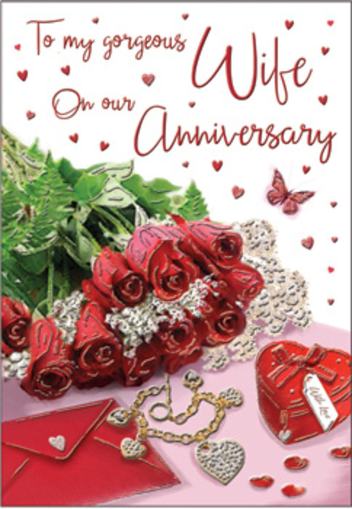 A romantic still life reminiscent of a cosy Canonbury townhouse interior spreads across this anniversary card, composed with the calm confidence of an experienced florist's hand. At the centre rests a generous cluster of traditional red roses, each bloom plush and perfectly formed, their petals unfolding in abundant layers that curl softly at the edges. The roses are nestled among glossy green foliage, creating a lush contrast that makes their crimson tones appear even deeper and more passionate, as though they carry all the warmth of years spent together. Closely placed beside them is a neatly positioned envelope, hinting at a handwritten message, while a small heart-shaped box and a delicate piece of jewellery complete the intimate portrait. Their metallic accents and smooth finishes catch the light like glimmers of shared memories-anniversary dinners on nearby Upper Street, quiet strolls through Highbury Fields, and evenings spent reminiscing at home. Scattered miniature hearts, both flat and slightly raised, trail across the card in a gentle cascade, leading the eye towards a butterfly motif that adds a touch of whimsy, like a symbol of transformation and lasting devotion. The background shimmers softly in pale tones, providing a serene canvas that lets the red roses and romantic keepsakes stand out with clarity. Although the card's message is not fully legible, the flowing, elegant script suggests words spoken from the heart. The overall composition feels both polished and deeply personal, echoing the way couples in Canonbury choose thoughtful, timeless gestures to celebrate an anniversary that is less about spectacle and more about the enduring beauty of everyday love.