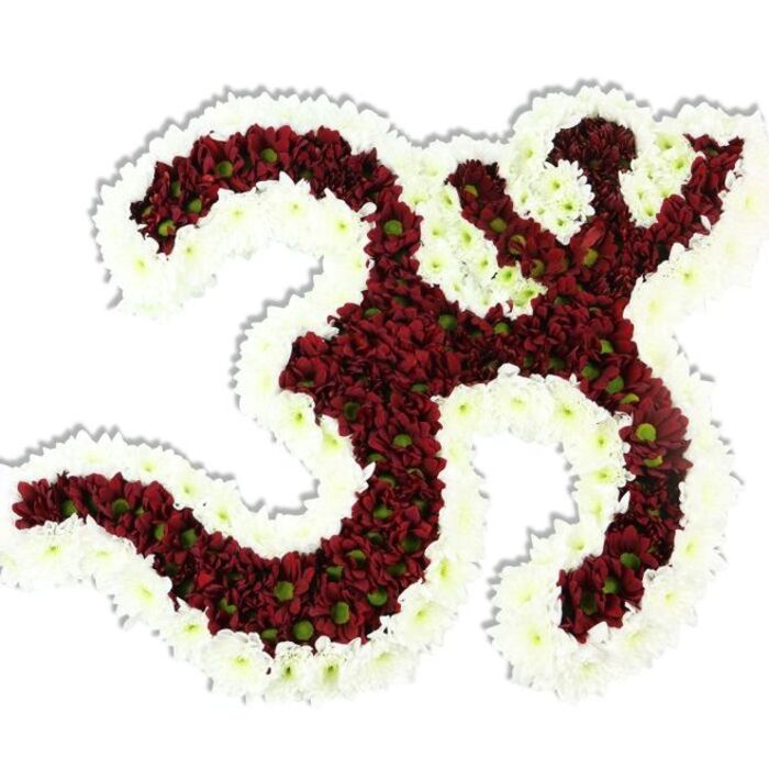 An expertly composed floral depiction of the Om sign, presented on a stark white background so that every curve and negative space is immediately legible. The core of the symbol is formed from thousands of small, tightly clustered maroon and deep red chrysanthemum-like blooms that give the design a plush, almost textile depth; many of these blooms reveal subtle lime-green centres that introduce delicate variation and a living feel to the crimson field. Framing the interior is a robust, undulating band of bright white spray chrysanthemums, whose crisp petals outline the '3'-shaped loop, the downward S-stroke, and the crescent with bindu with luminous clarity. The massing of flowers creates a soft, layered texture that reads as both tender and formal - petals imagined as cool and satiny beneath the hand. A slight drop shadow underlines the arrangement's three-dimensional form and the careful sculptural technique behind it. From the perspective of a Canonbury-based floral studio, the piece is suitable for solemn memorials, community pujas, or contemplative events held in nearby venues such as Canonbury Square Gardens or a small hall off Upper Street, where quiet dignity is required. The image communicates meticulous workmanship: precise placement, attention to proportion, and thoughtful contrast between dark and light that together make the symbol arresting and easy to read. It evokes themes of spiritual unity, quiet respect, and the craftsmanship of a florist composing a meaningful tribute for rituals and remembrance.