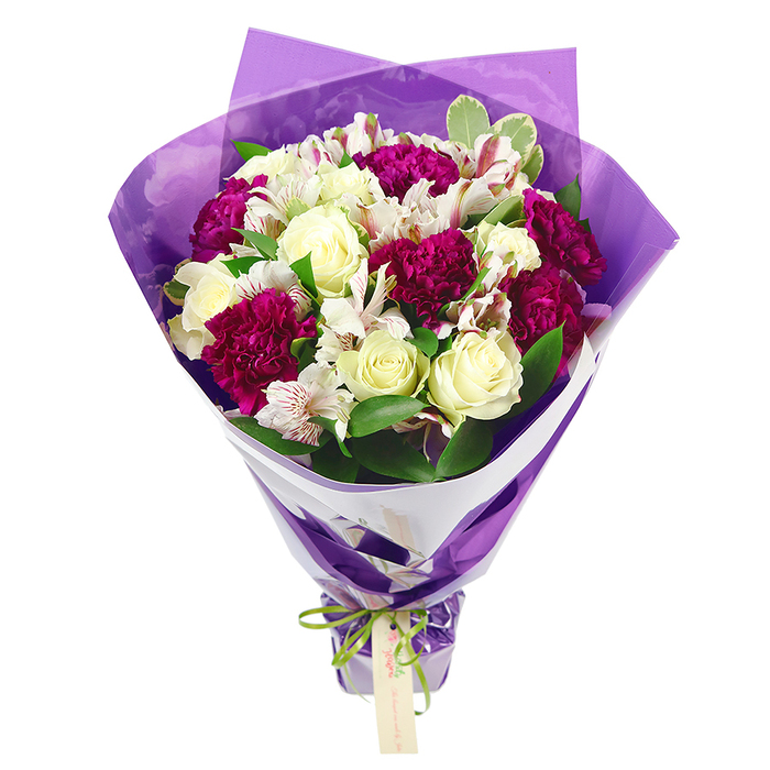 In this image, a beautifully composed bouquet of fresh flowers stands out crisply against a white background, highlighting each bloom as if it has just been arranged in a Canonbury florist's studio. The central focus is on elegant cream-white roses, their petals unfurling in tight, symmetrical swirls that suggest a soft, classic fragrance and a sense of refined romance. Encircling them are deep magenta and fuchsia carnations, their frilled, densely layered petals creating generous cushions of colour and texture that instantly draw the eye. Interspersed among these are white alstroemeria, also known as Peruvian lilies, their slender petals delicately marked with fine pinkish-red streaks and centered with dark stamens, bringing a gentle, intricate detail that rewards a closer look. Fresh green foliage, including glossy leaves and some with pale variegated edges, provides a lively contrast and makes the colours of the roses and carnations appear even more vivid. The bouquet is shaped into a rounded, full crown of blooms at the top, with stems tapering neatly downward, giving a classic hand-tied silhouette often chosen for celebrations across Canonbury and nearby Islington. The stems are cradled in a snug inner layer of crisp white wrapping paper, folded into a neat collar that keeps the composition tidy and elegant. Over this sits an outer wrap of translucent purple cellophane, softly crinkled so that it catches the light and adds a shimmering sense of festivity. At the base, a bright, iridescent green satin ribbon is tied in a simple, cheerful bow, from which a small pale brown gift tag dangles, ready for a handwritten note. The overall effect is joyful yet sophisticated, suitable for birthdays, congratulations, or just-because deliveries to homes and offices throughout Canonbury.