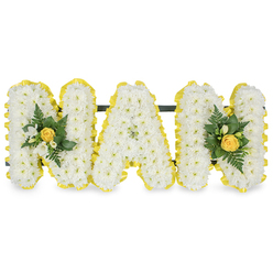 This graceful tribute, intended to honour a cherished grandmother, spells out MAM in three sculpted capital letters each densely covered in tiny white chrysanthemum sprays that create a soft, cloud-like surface. The pristine white of the chrysanthemums reads as calm and pure, while two small floral clusters at either end gently lift the composition: each cluster is centred on a tightly furled yellow rose, its warm petals promising a quiet, sunny solace, accompanied by delicate white freesia buds and sprigs of deep green fern and glossy foliage which add coolness and texture. A pleated ribbon in a clear sunny yellow traces the outer contour of every letter, its folded sheen providing a crisp, uplifting frame against the white petals and reinforcing the letterforms with a neat, finished edge. Behind the upper sections a slim, dark support bar runs horizontally to keep the letters steady when displayed on a chapel easel or at a graveside. Photographed on a plain white background in soft daylight, you can imagine the subtle scent of freesia lifting from the cluster accents and the tactile contrast between the chrysanthemums' feathery blooms and the ribbon's satiny pleats. As a local florist who has prepared memorials for families from Canonbury Square to Essex Road, I picture this piece placed near a favourite bench in New River Walk or beside a service at a small parish, offering a composed, personal expression of remembrance and warmth.