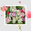 The image shows a generous, tightly gathered bouquet of roses designed to illustrate a 12-month flower subscription, as if capturing the ongoing pleasure of fresh deliveries to Canonbury homes in a single frame. At the centre, full-headed roses in blush pink, creamy ivory, raspberry red, and gentle lilac are packed closely together, creating an impression of abundance and intimacy. The petals are lush and velvety, some curling outward in wide, open rosettes, others still cradling their centres in half-open buds that suggest the unfolding of future months. Rich green foliage surrounds and supports the blooms, its glossy leaves providing a vivid contrast to the soft, pastel hues and deeper pops of magenta. The light is calm and diffused, washing across the arrangement in a way that makes each petal appear almost luminous against a clean, neutral background, like bouquets resting on a polished table in a Canonbury townhouse near Highbury Corner. Around the central cluster, a halo of scattered petals and small blossoms seems to float in mid-air, drawing the eye inwards while hinting at movement and celebration, much like confetti caught in a gentle breeze on a wedding day in nearby Islington. You can almost sense the cool silk of the petals and the fresh, slightly sweet fragrance that might drift through an open window on a quiet afternoon. The mood is one of quiet, enduring joy, perfectly suited to birthdays, anniversaries, or simple everyday uplift, reflecting the thoughtful artistry and care that go into monthly rose deliveries across the N1 community.