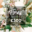 An exquisite Florist Choice bouquet blooms in a softly blurred peach-toned backdrop, a testament to Canonbury Flowers' careful hand. The composition centers on several large ivory blooms-garden roses, peonies, or gardenia-like blossoms-set off by smaller white flowers such as lisianthus, with sprigs of waxflower adding dainty warmth. The greenery is lush and varied: rounded eucalyptus leaves, olive sprigs for a Mediterranean lift, and tiny pale-green buds that catch the light. A striking, darker green ornamental kale or succulent head sits near the heart, lending a modern edge to the classic palette. A clean white rectangular frame overlays the arrangement, holding Florist Choice in an elegant script and CHOICE in uppercase sans-serif, with the large '?300' beneath in white sans-serif. The background remains softly out of focus in warm cream and peach tones, ensuring the bouquet reads as both luxurious and natural. This image captures a premium gift option that would shine in Canonbury and across Islington, ideal for delivery to Canonbury residents, whether for birthdays, anniversaries, or new arrivals to the neighbourhood. The bouquet communicates expert curation, freshness, and craftsmanship, with a design sensibility that suits contemporary homes on nearby streets such as Essex Road, New North Road, and Upper Street. For those seeking same-day delivery across Canonbury, this Florist Choice arrangement offers a sophisticated, lasting impression that travels with care from our shop to the recipient's door.