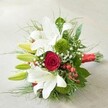 Viewed at a gentle angle against an inviting, softly textured background, this luminous Canonbury bouquet showcases an exquisite fusion of traditional and modern floral artistry. Bold white lilies unfurl their elegant, trumpet-shaped petals, some edged with soft hints of burgundy, their presence radiating purity and serenity. Tucked in the heart, a singular deep red rose mesmerizes with its velvet spiral, evoking deep passion and the romance often celebrated along Canonbury's charming streets. Multitudes of vibrant lime-green lily buds and airy, feathery sprigs provide notes of freshness and anticipation, harmonising with moss-green spheres reminiscent of the lush greenspaces of Arlington Square. Clusters of crisp red hypericum berries offer vivid contrast, while gentle baby's breath seems to drift through the bouquet like a whisper, lightening the design and amplifying its sense of abundance. Surrounding these are broad, deep green foliage creating structure and depth, enhancing the interplay of colour and texture. The bouquet's stems are wrapped elegantly with glowing red satin ribbon, creating a cohesive and polished finish that ties the entire composition together. Lovingly assembled by Canonbury Flowers, this arrangement is ideal for same-day delivery across Islington for weddings, heartfelt anniversaries, or moments that call for a gesture as memorable as the neighbourhood itself.